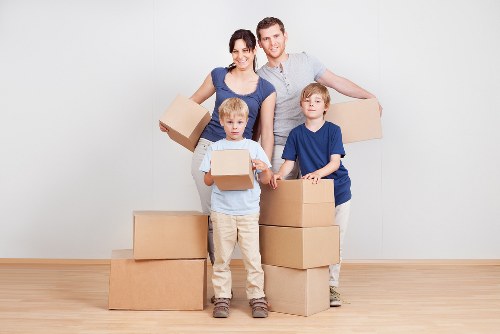 Removal van and movers managing access near Acton flats and homes