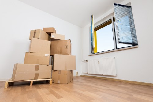 Packed household boxes and furniture ready for transport in Acton